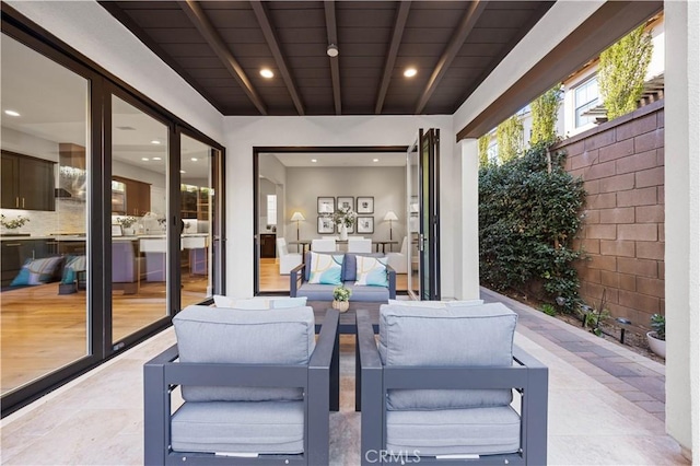 view of patio / terrace with outdoor lounge area and fence