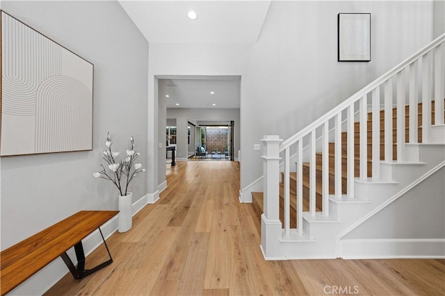 entryway featuring stairway, recessed lighting, wood finished floors, and baseboards