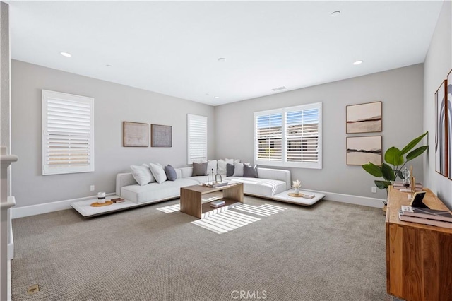 carpeted living area featuring recessed lighting and baseboards