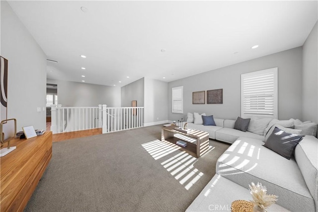 living room featuring recessed lighting, carpet flooring, and baseboards