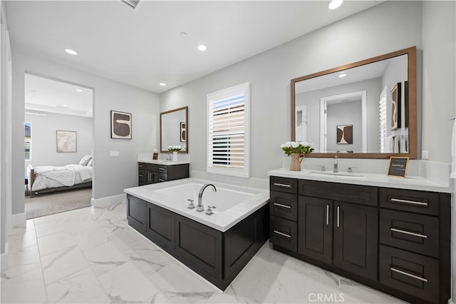 ensuite bathroom with marble finish floor, a garden tub, recessed lighting, connected bathroom, and a sink