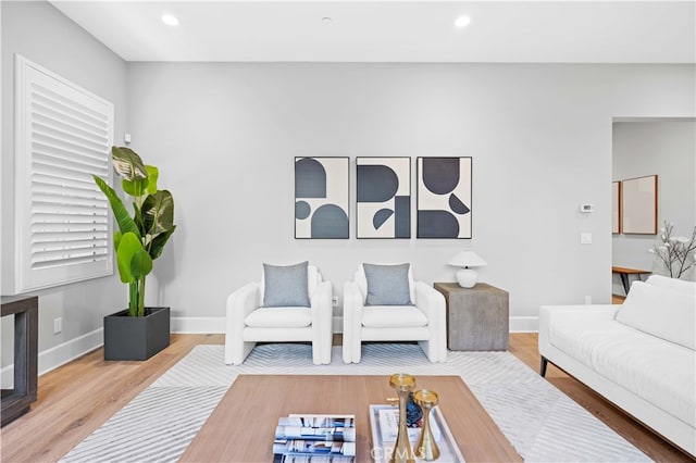 living room with recessed lighting, baseboards, and wood finished floors