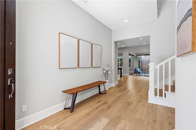 entrance foyer featuring light wood finished floors, baseboards, visible vents, stairway, and recessed lighting