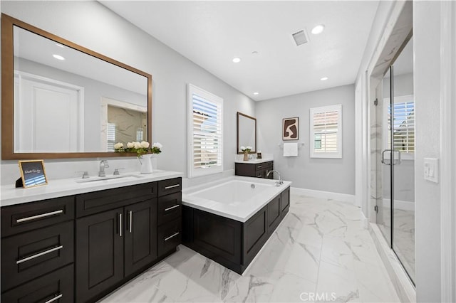 bathroom with a sink, marble finish floor, a shower stall, a bath, and recessed lighting