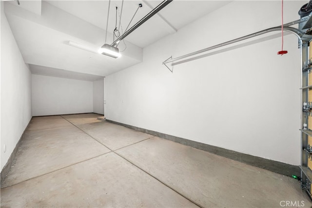 garage featuring baseboards and a garage door opener