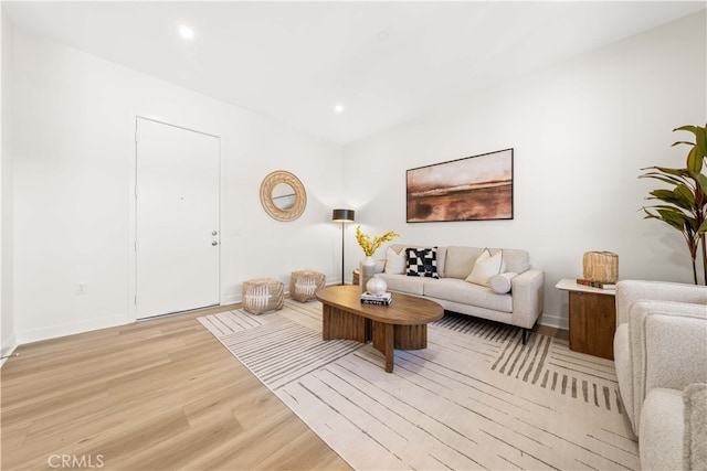 living area with light wood finished floors, baseboards, and recessed lighting