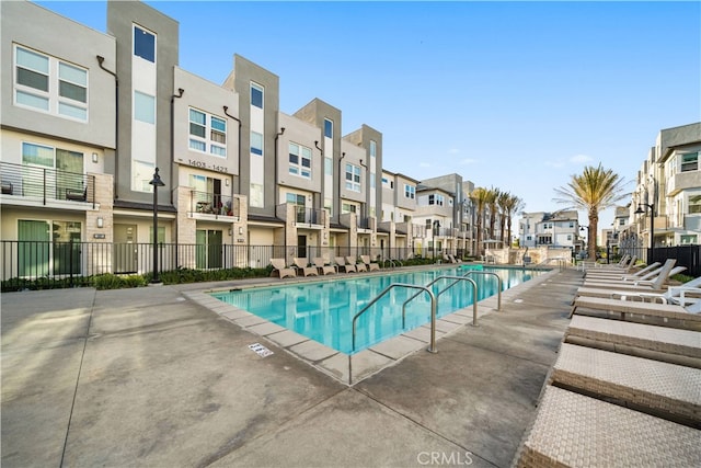 pool featuring fence and a residential view