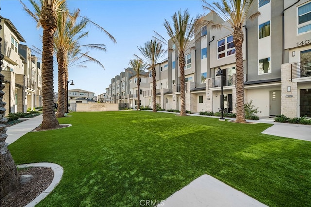 view of community with a yard and a residential view