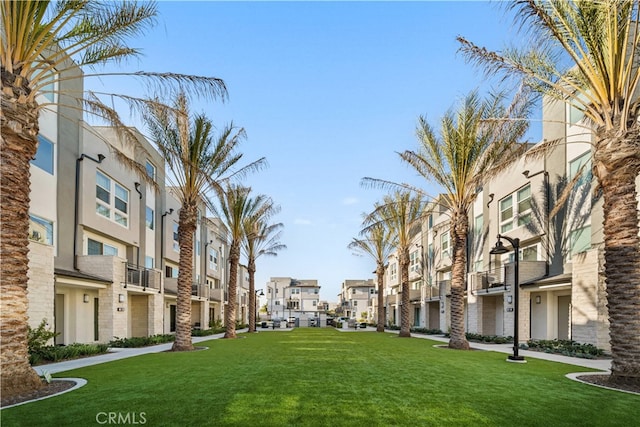 view of home's community featuring a residential view and a yard