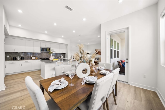 dining room with light wood-style floors, visible vents, and recessed lighting