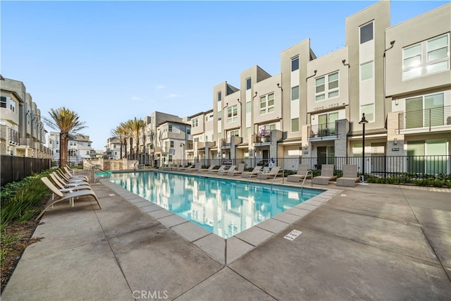 pool featuring a residential view, fence, and a patio