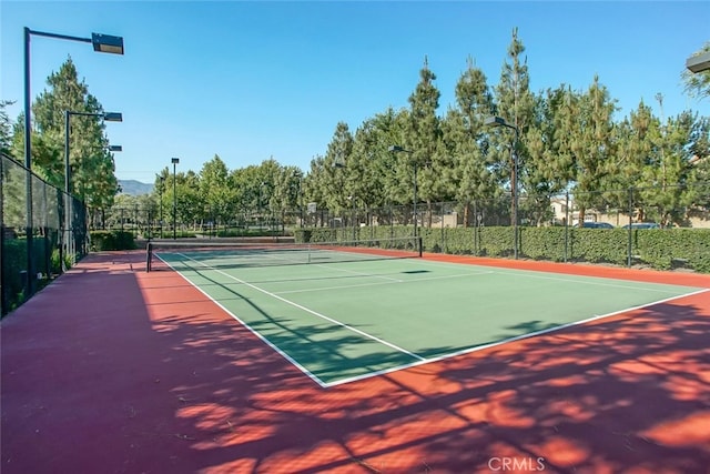 view of tennis court with fence