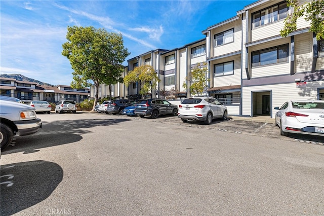 uncovered parking lot featuring a residential view