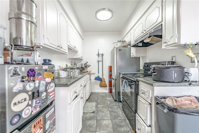 kitchen featuring under cabinet range hood, electric range, white cabinetry, and freestanding refrigerator