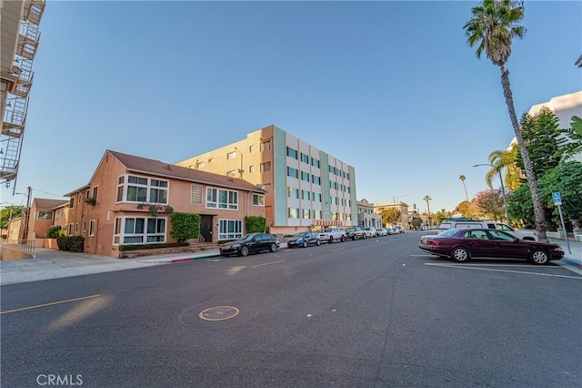 exterior space featuring curbs, street lighting, and sidewalks