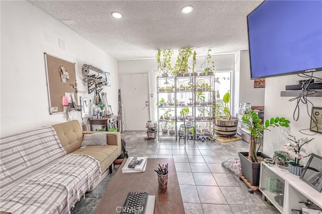 living room featuring recessed lighting, a textured ceiling, and tile patterned floors