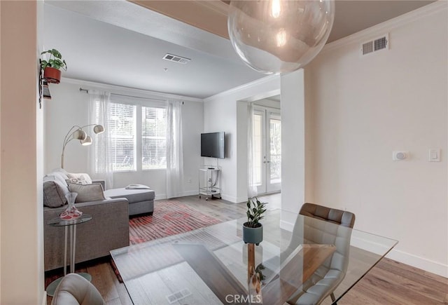 living room with french doors, visible vents, ornamental molding, wood finished floors, and baseboards