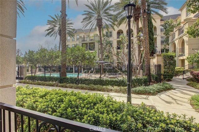 view of home's community featuring fence and a pool