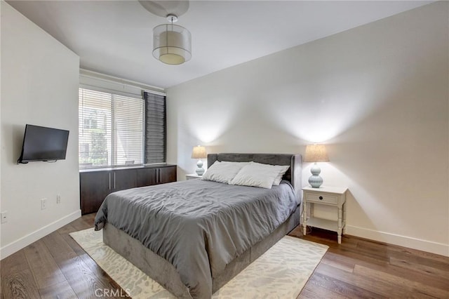 bedroom featuring baseboards and hardwood / wood-style floors