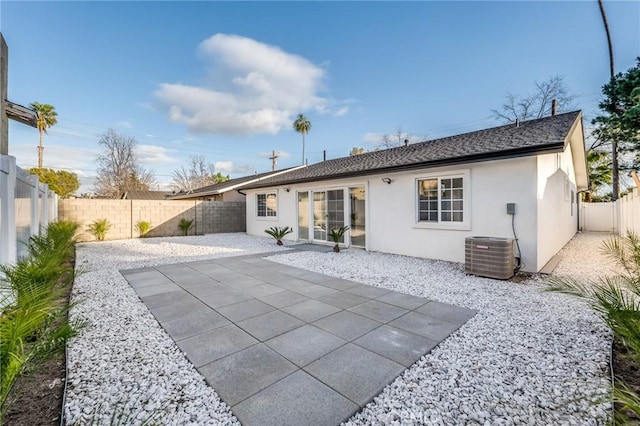 rear view of house featuring stucco siding, a patio, central AC, and a fenced backyard