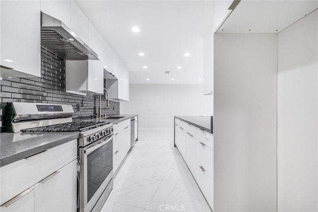 kitchen featuring a sink, stainless steel appliances, wall chimney exhaust hood, modern cabinets, and marble finish floor