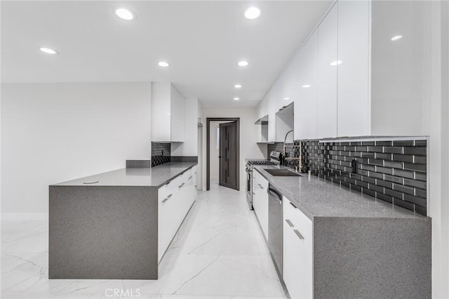 kitchen with stainless steel appliances, marble finish floor, modern cabinets, and white cabinetry