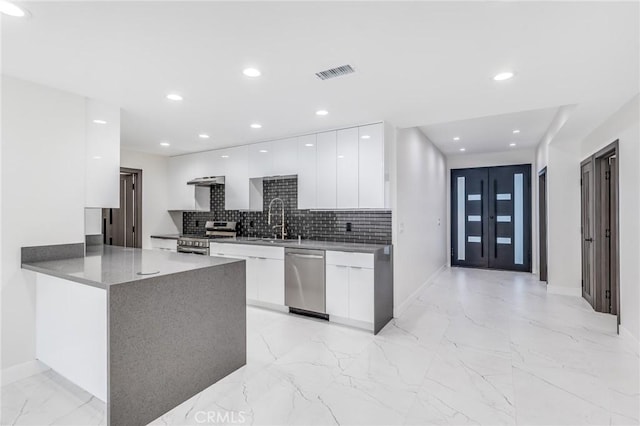 kitchen featuring stainless steel appliances, marble finish floor, modern cabinets, and white cabinetry