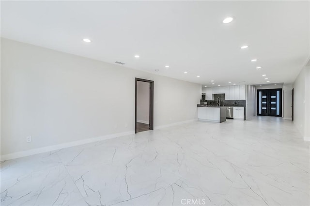 unfurnished living room featuring visible vents, recessed lighting, marble finish floor, and baseboards