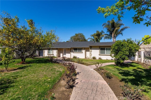 single story home featuring fence, a front lawn, and stucco siding