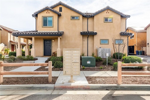 view of front of property with a tile roof and stucco siding