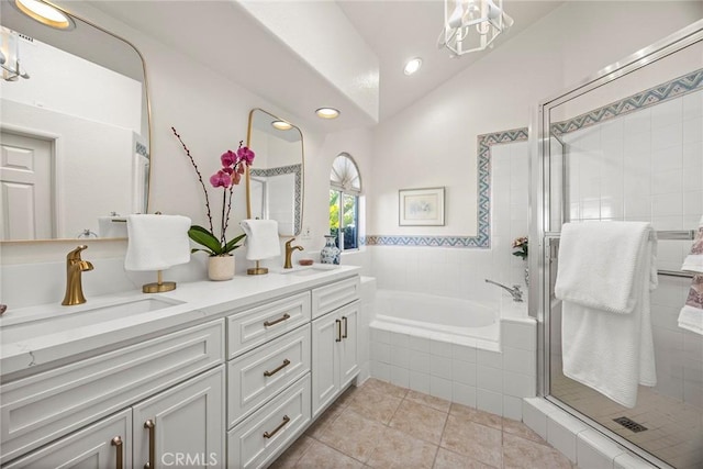 bathroom with vaulted ceiling, a garden tub, a sink, and a shower stall