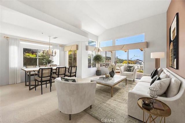 living area with a wealth of natural light, light colored carpet, vaulted ceiling, and a chandelier