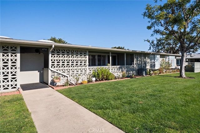 ranch-style home with central AC unit and a front yard