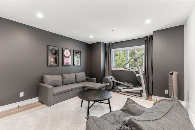 living area with recessed lighting, wood finished floors, and baseboards