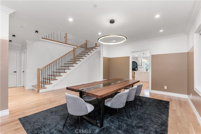 dining room featuring stairs, ornamental molding, and light wood-style floors