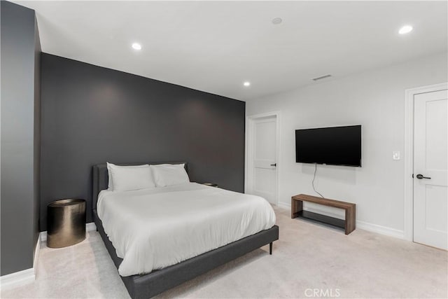 bedroom with recessed lighting, light colored carpet, visible vents, and baseboards