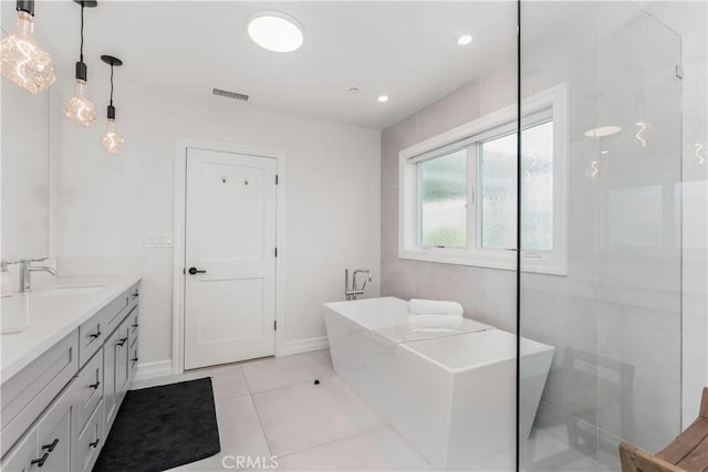 full bath featuring double vanity, a soaking tub, visible vents, a sink, and tile patterned flooring