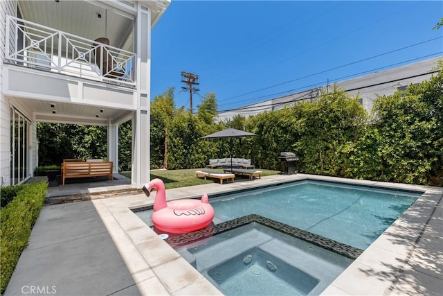 view of swimming pool featuring a patio, outdoor lounge area, a grill, and a pool with connected hot tub