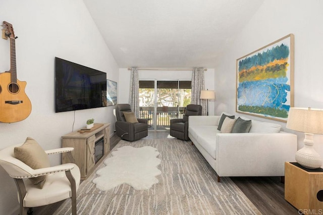 living room featuring vaulted ceiling and wood finished floors