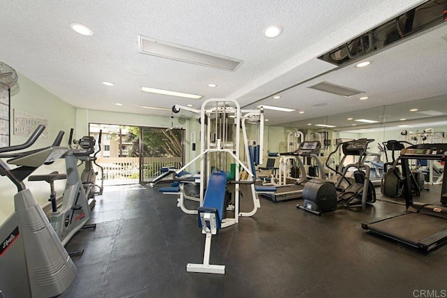 workout area with recessed lighting and a textured ceiling