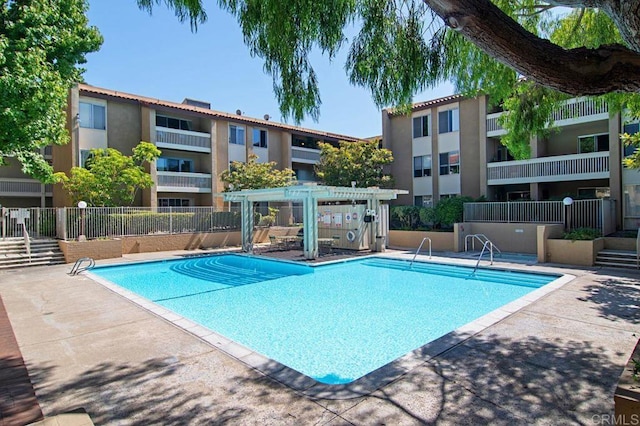 pool featuring a patio and fence