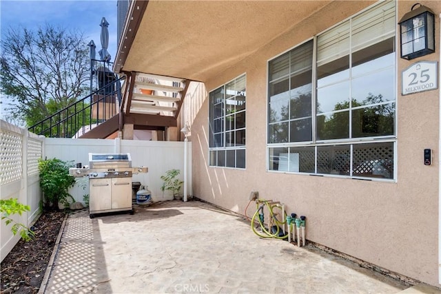 view of patio / terrace featuring a fenced backyard and a grill