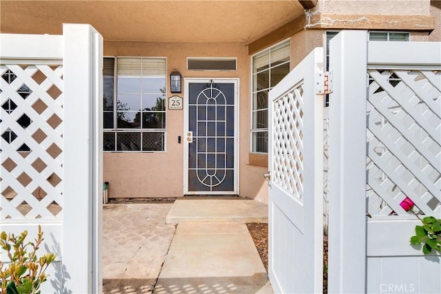 entrance to property featuring stucco siding