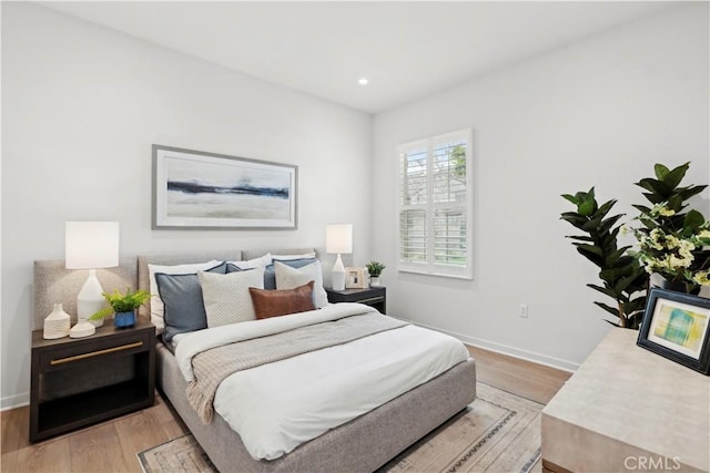 bedroom featuring recessed lighting, light wood-style flooring, and baseboards