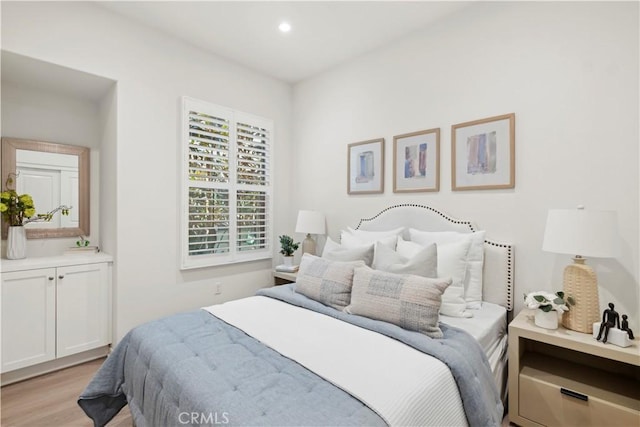 bedroom with light wood-type flooring and recessed lighting