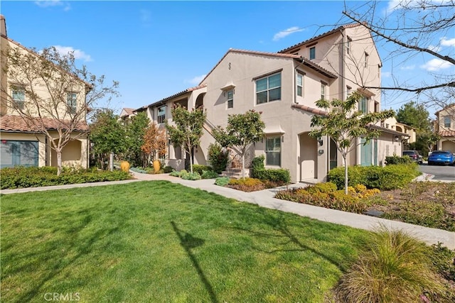 mediterranean / spanish-style house with a front lawn and stucco siding