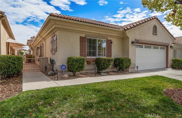 mediterranean / spanish-style house featuring a tiled roof, an attached garage, a gate, and stucco siding