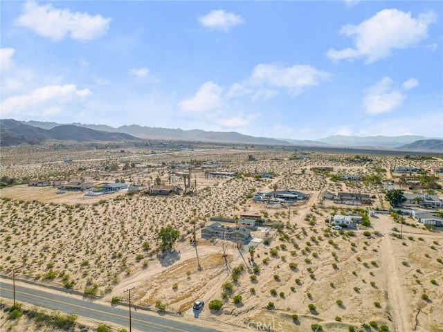 bird's eye view featuring a mountain view, a desert view, and a rural view