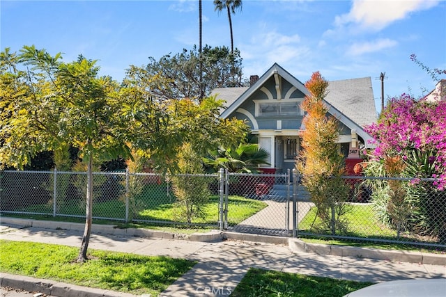 view of front of home with a fenced front yard and a gate