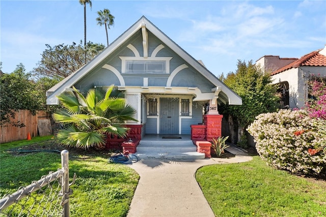 view of front of property with a front yard and fence